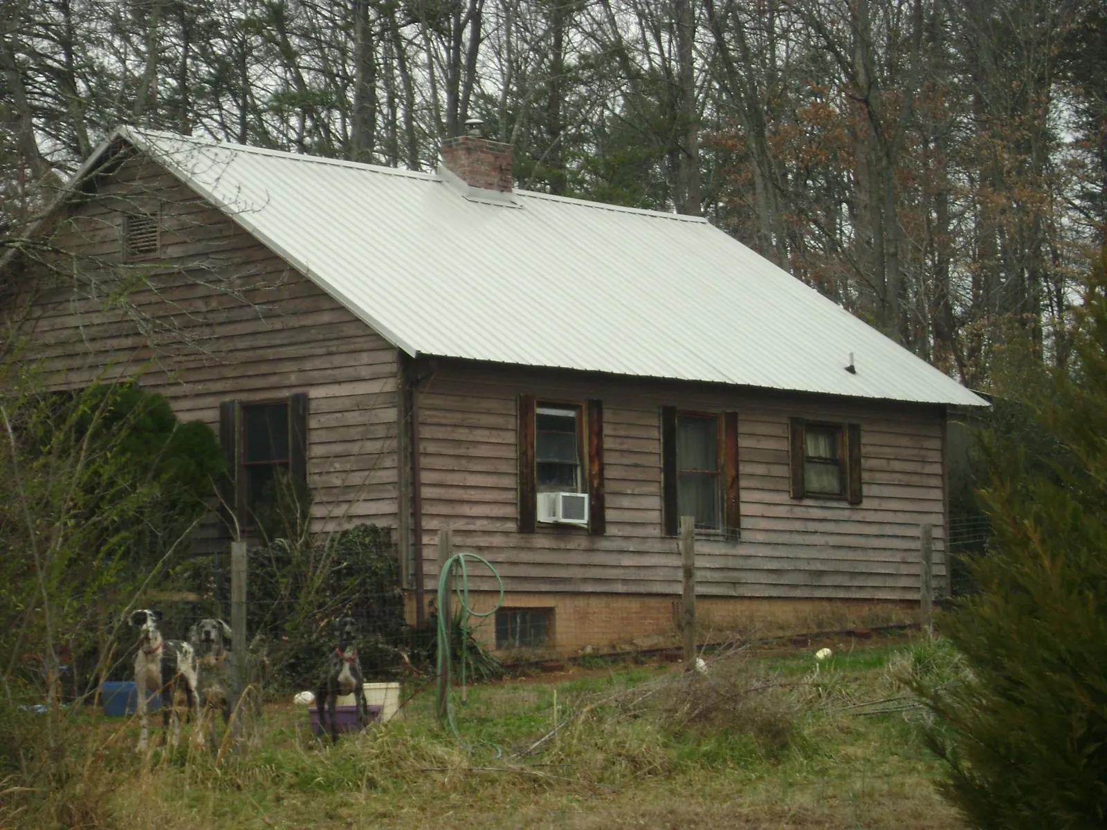 White metal roof on an old wood sided farmhouse, from a Metal Roof Installation job in Matteson